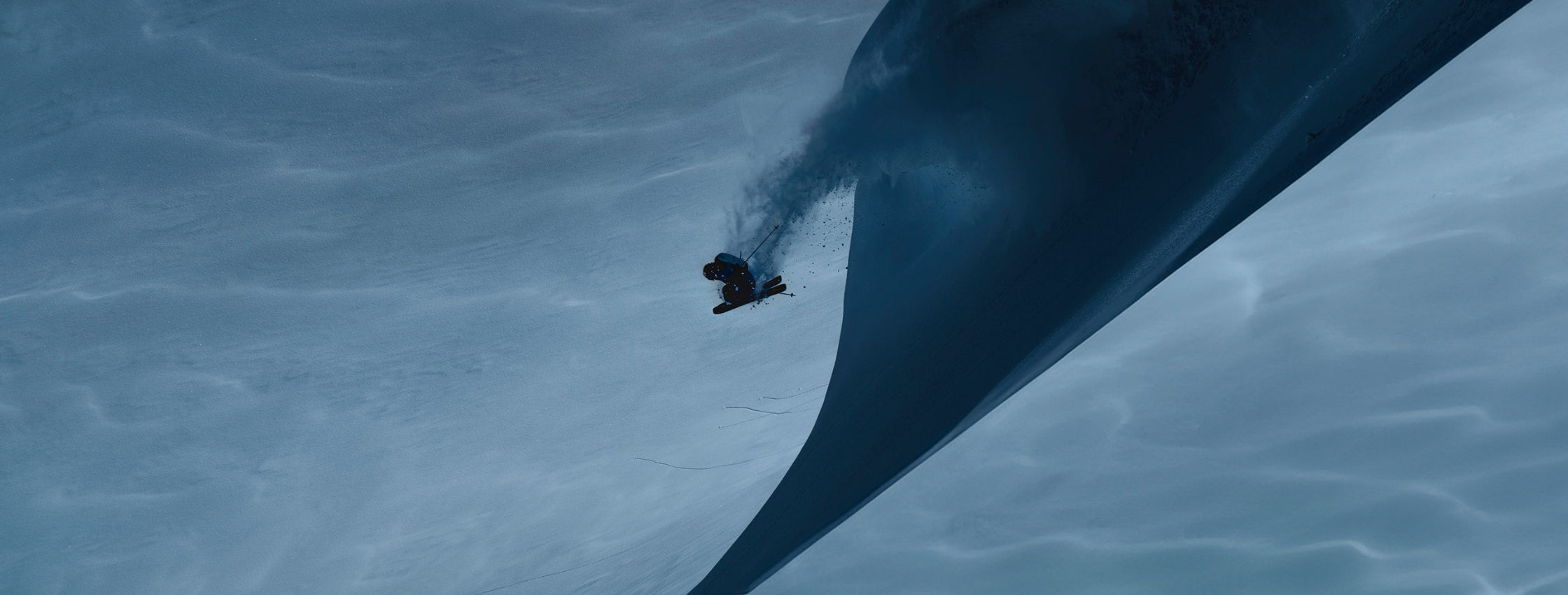 skier in air after a jump in a dark moody and showy landscape