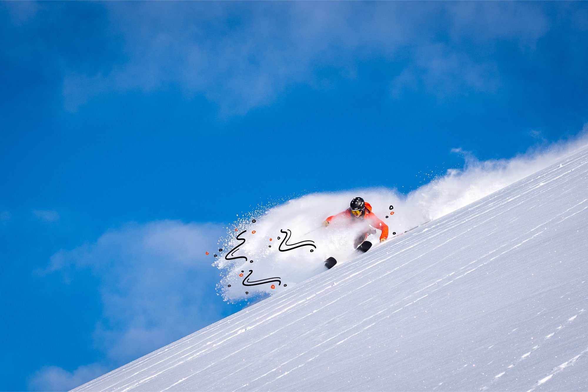 Skier in action on a snowy slope with a clear blue sky